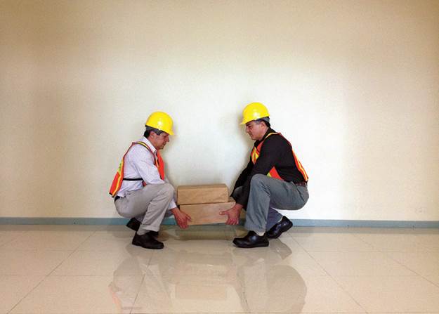 A couple of men wearing hard hats and lifting boxes

AI-generated content may be incorrect.