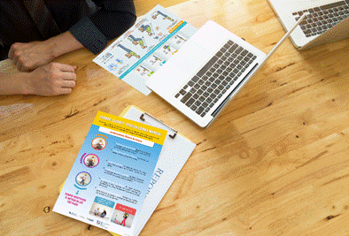 A person sitting at a table with a computer

AI-generated content may be incorrect.